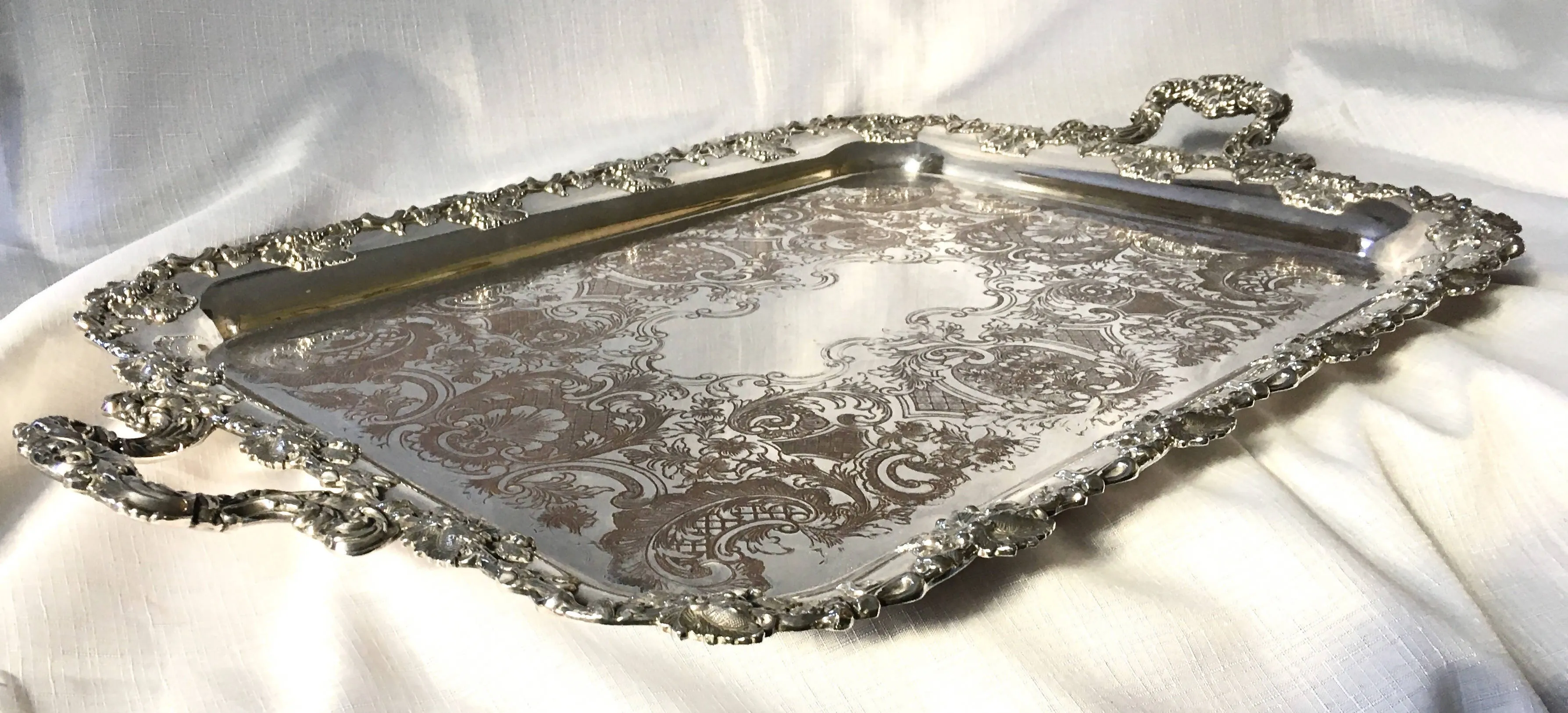 A 19th century ornate Sheffield Plated twin handled serving tray.