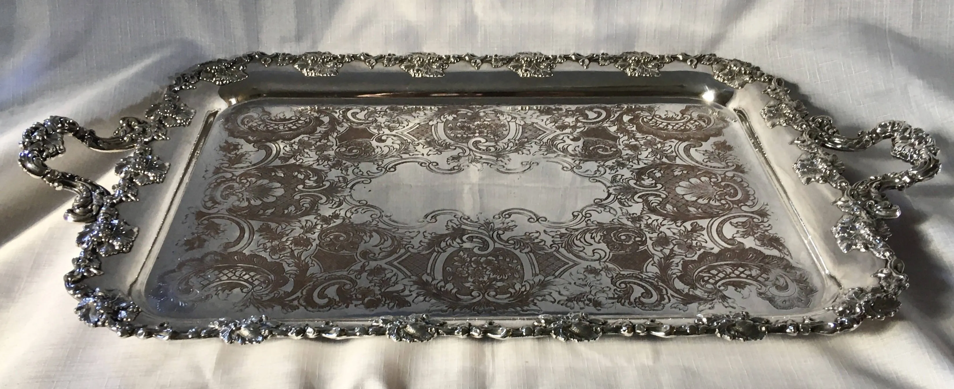 A 19th century ornate Sheffield Plated twin handled serving tray.