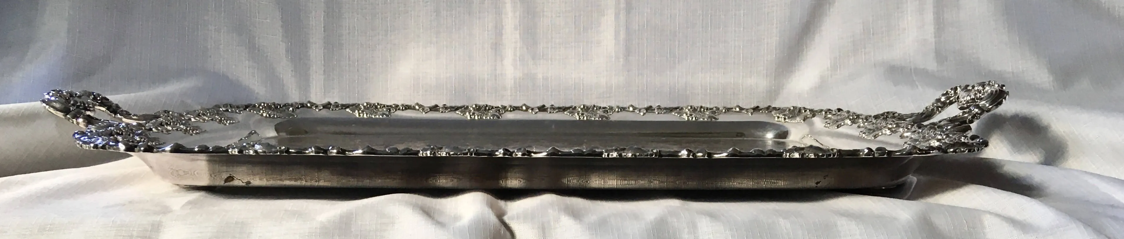 A 19th century ornate Sheffield Plated twin handled serving tray.