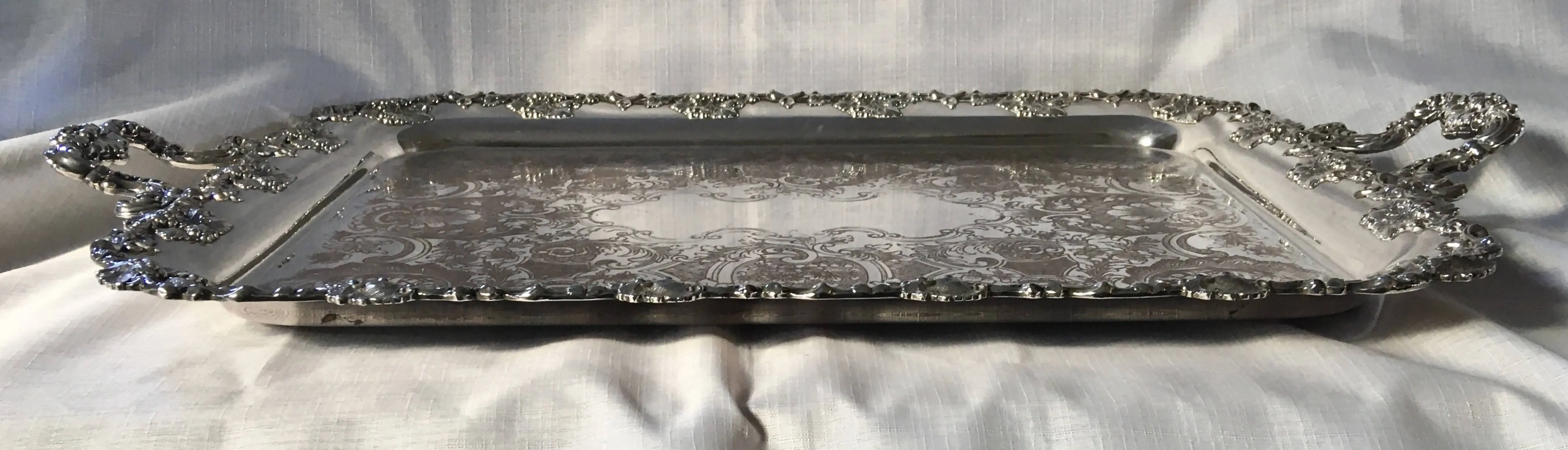 A 19th century ornate Sheffield Plated twin handled serving tray.