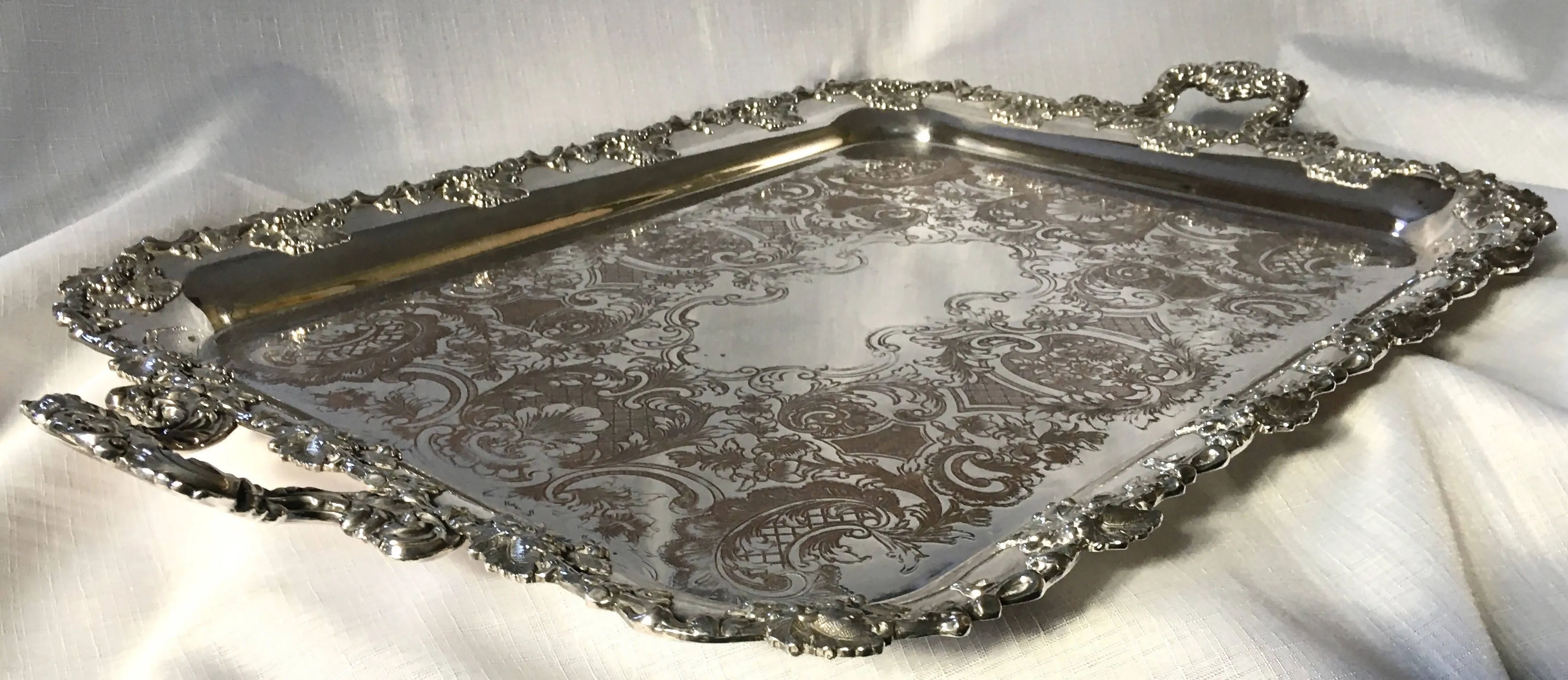 A 19th century ornate Sheffield Plated twin handled serving tray.